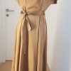 Schlichtes kupfergoldenes Seidenkleid mit Gürtel, hohem Kragen, überstehenden Ärmeln